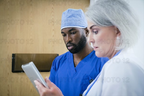 Doctor and nurse discussing digital tablet