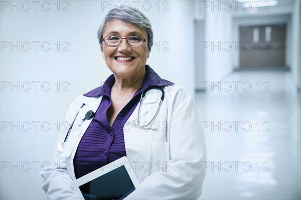 Portrait of smiling mixed race doctor