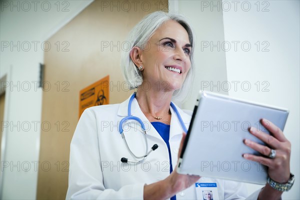 Caucasian doctor using digital tablet