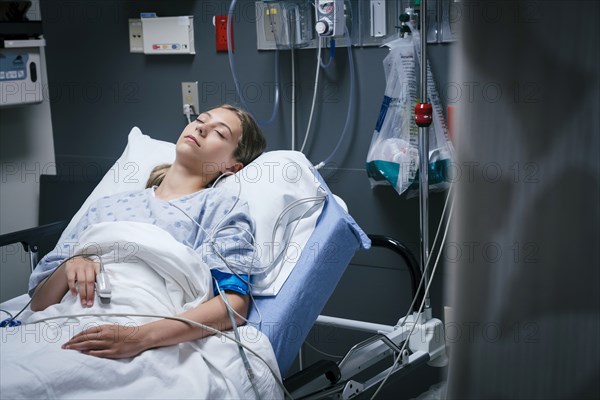 Caucasian girl sleeping in hospital bed