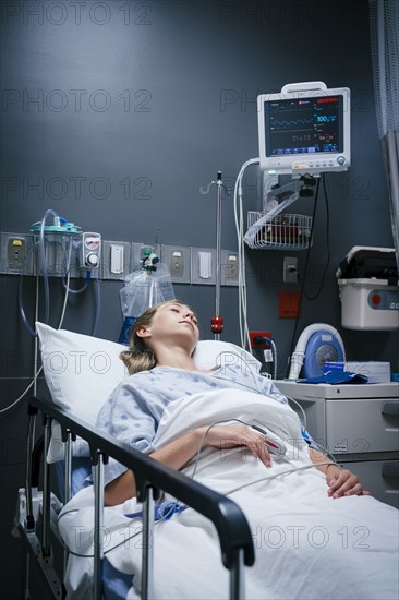 Caucasian girl sleeping in hospital bed