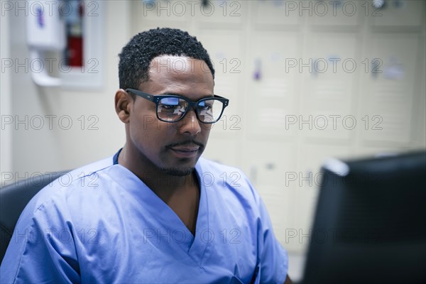 Black nurse using computer