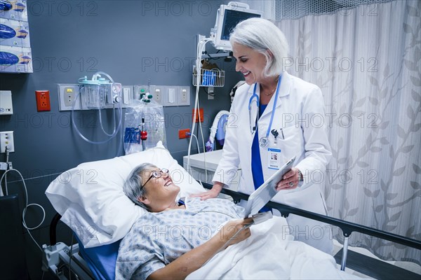 Doctor showing digital tablet to patient