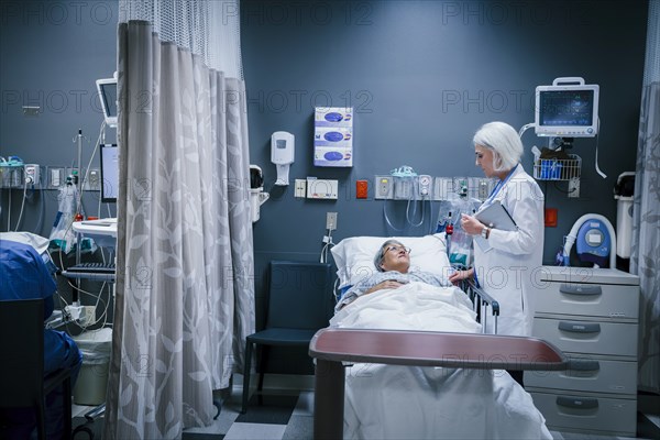 Doctor talking to patient in hospital bed