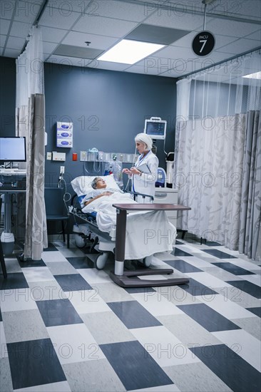 Doctor talking to patient in hospital bed