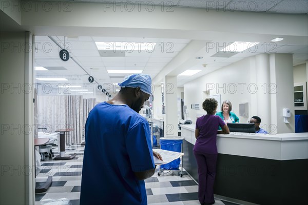 Nurse reading paperwork in hospital