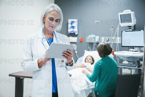 Caucasian doctor using digital tablet in hospital