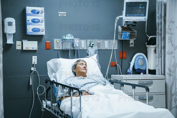 Mixed race patient sleeping in hospital bed