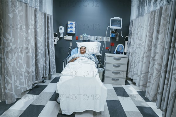 Mixed race patient sleeping in hospital bed