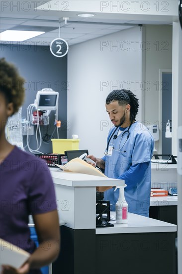 Nurse scanning paperwork in hospital