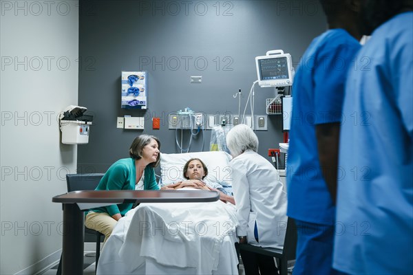 Doctor talking to mother and daughter in hospital