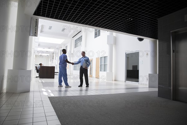 Doctor and nurse shaking hands