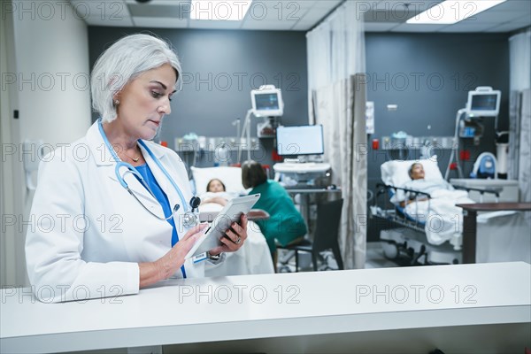 Doctor using digital tablet in hospital