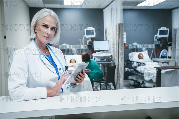 Doctor using digital tablet in hospital