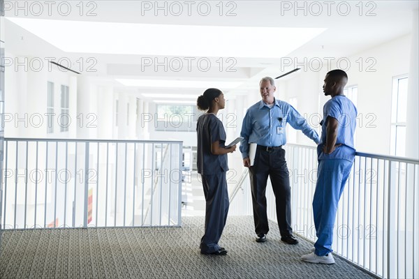 Doctor and nurses talking near staircase