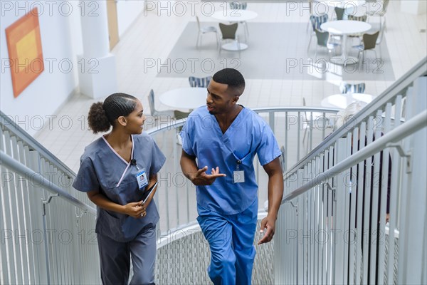 Nurses climbing staircase and talking