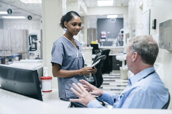 Doctor and nurse talking in hospital