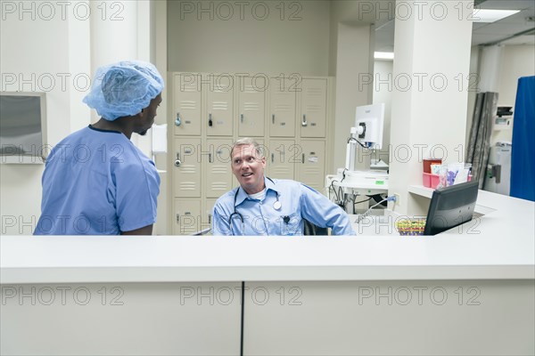 Doctor and nurse talking in hospital