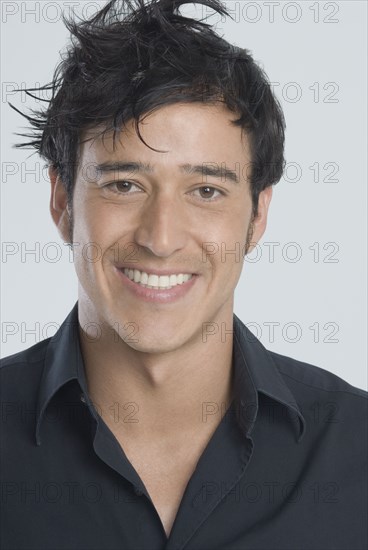 Hispanic man with messy hair