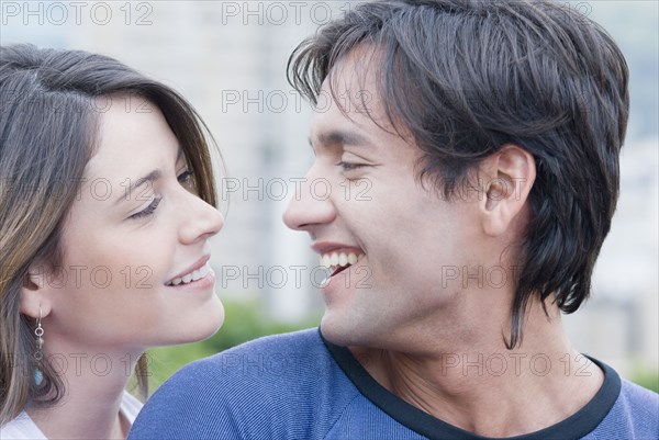 Hispanic couple smiling at each other