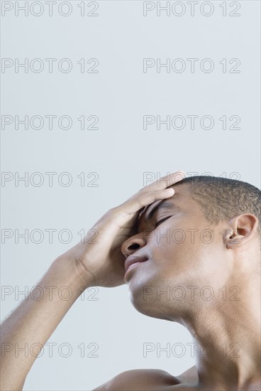 African man with hand on head