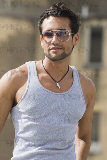 Hispanic man wearing sunglasses