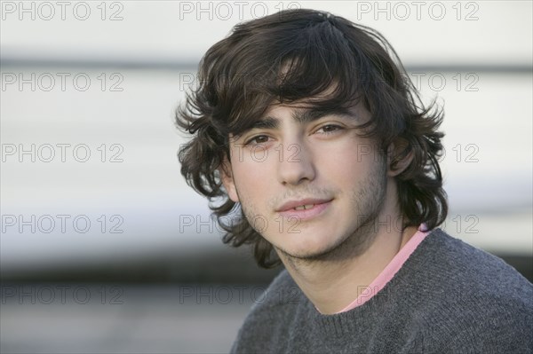 Young Hispanic man wearing sweater