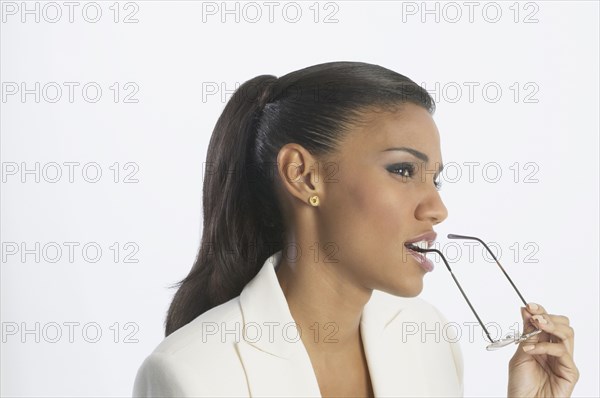 African businesswoman holding eyeglasses