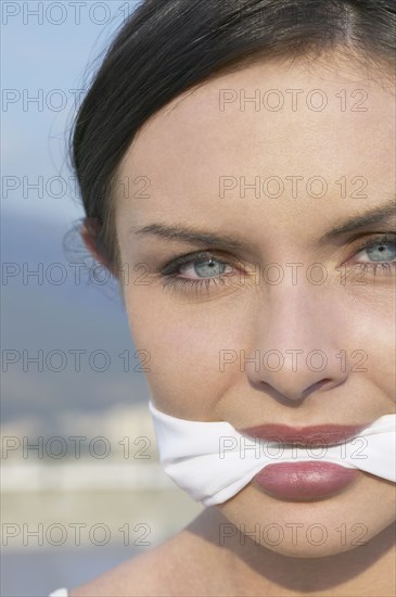 Young woman wearing gag