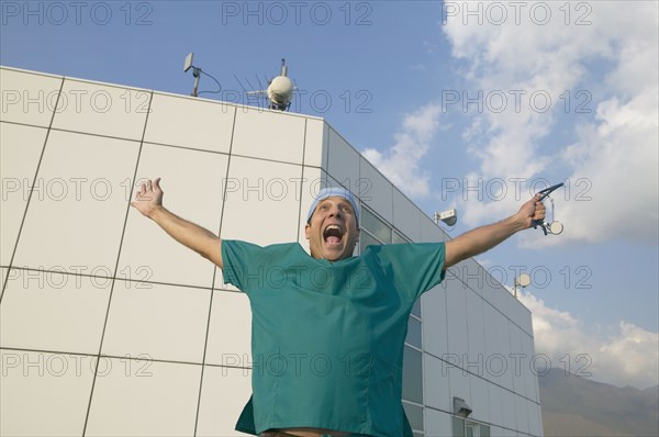 Hispanic male doctor with arms outstretched