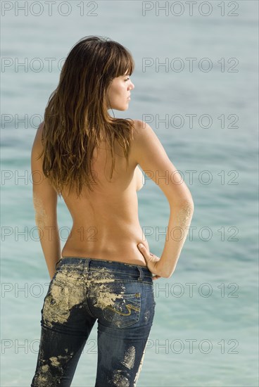 Semi-nude young woman at beach