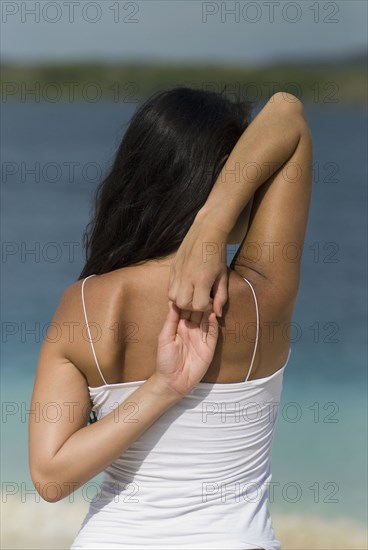 Hispanic woman stretching