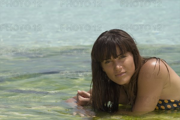Young woman laying in water
