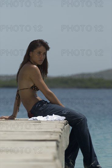 Young woman sitting on dock