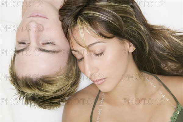 Multi-ethnic couple with heads touching