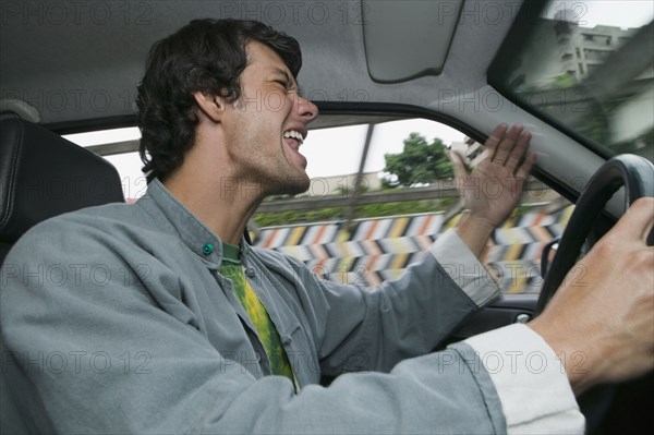 Hispanic man yelling and driving