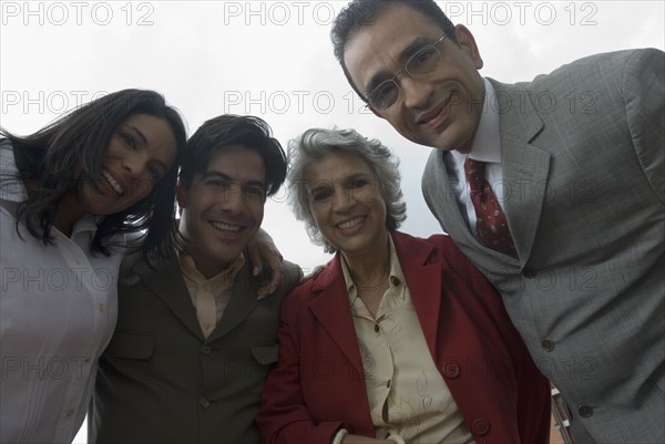 Hispanic businesspeople in huddle