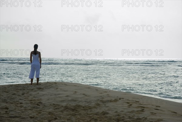 Woman looking out over ocean
