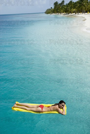 Woman on float in water