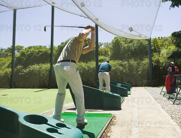 Hispanic man playing golf