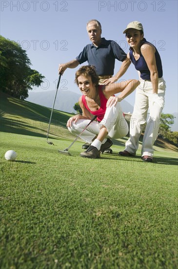 Multi-ethnic friends playing golf