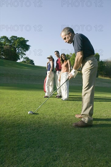 Hispanic man playing golf