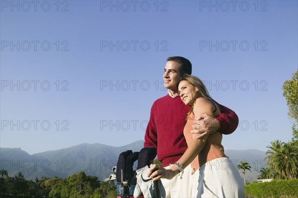 Multi-ethnic couple on golf course