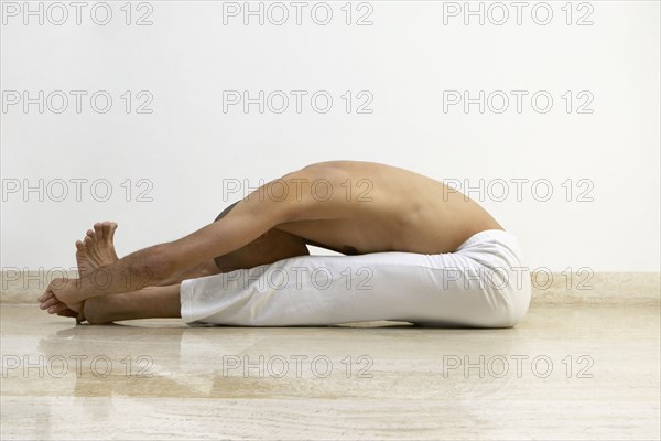 Man stretching indoors