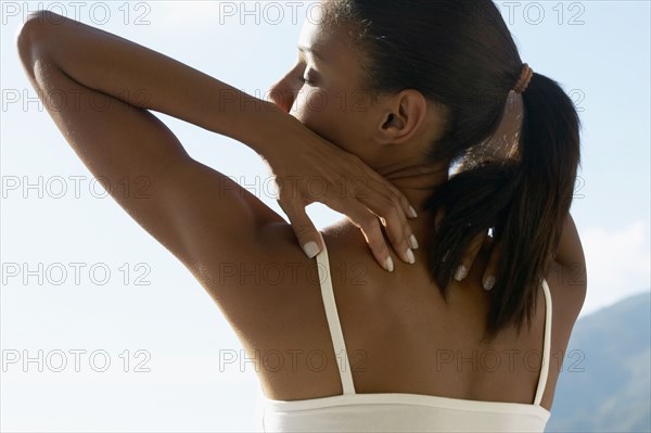Rear view of African woman stretching outdoors