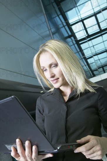 Russian businesswoman holding laptop