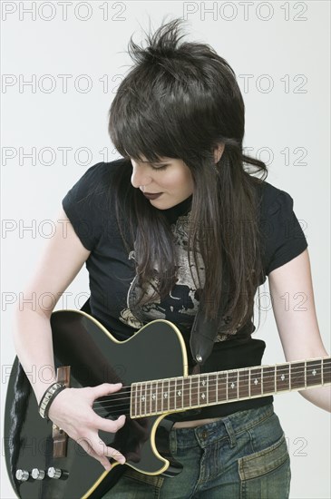 Hispanic woman playing guitar