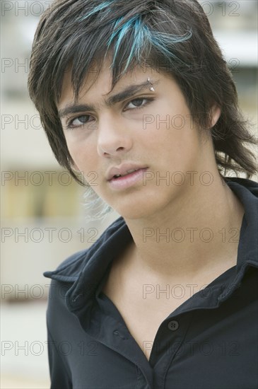 Hispanic teenager with eyebrow piercing