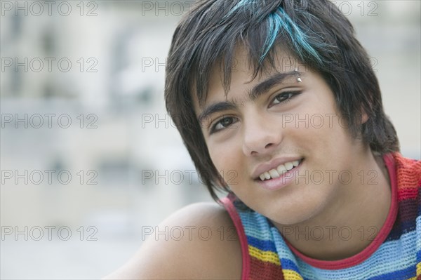 Hispanic teenager with eyebrow piercing