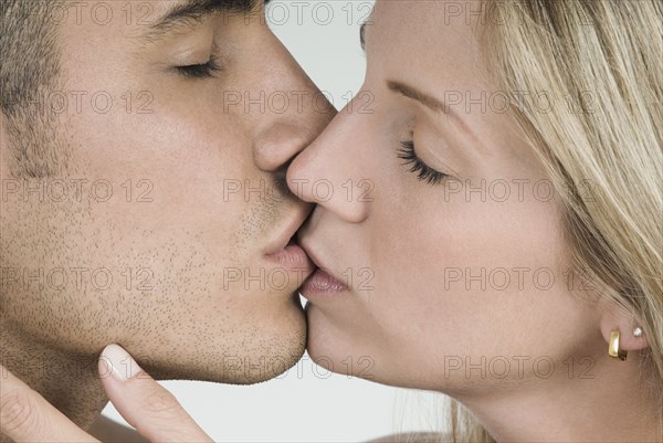 Close up of Hispanic couple kissing